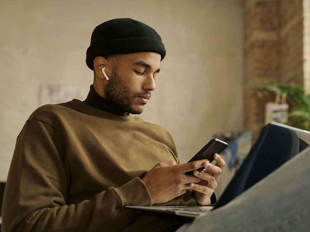 Young man on his phone and computer