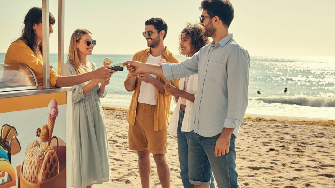 Groupe de jeunes achetant une glace avec leur carte Veracash à l'étranger